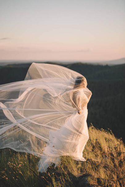 Beautiful bride outdoors in a forest. - Фото, изображение