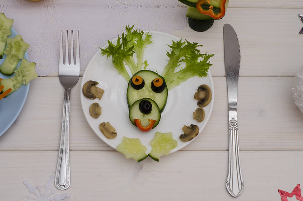 Edible Christmas deer made of vegetables for the festive New Year and Christmas table. Idea for decorating holiday dishes. How nice to serve vegetables and salad.  - Fotó, kép