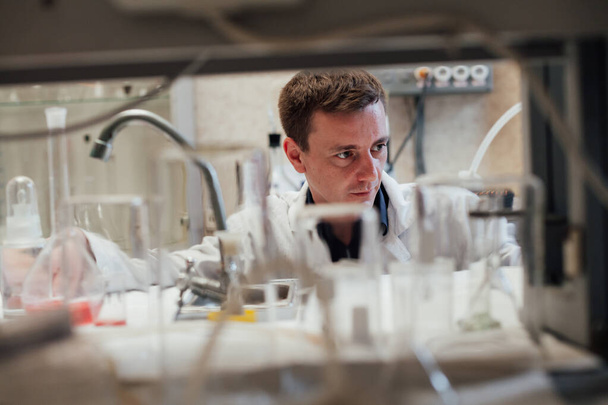 Chemiker experimentiert im Chemielabor mit Flüssigkeiten - Foto, Bild