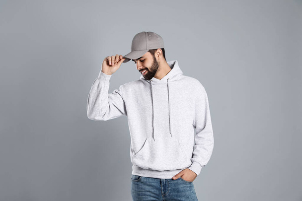 Portrait of young man in sweater on grey background. Mock up for design - Photo, Image
