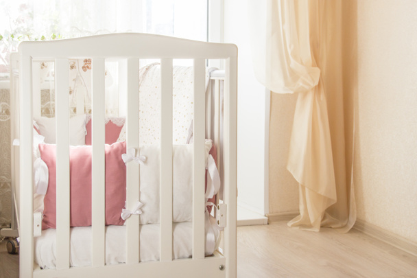 Baby bed crib with white and Burgundy color pillows with laces - Zdjęcie, obraz