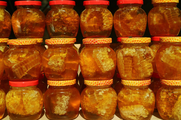 Natural Honey with Honeycomb in Glass Jars Selling in the Shop of Georgia Country - Фото, зображення