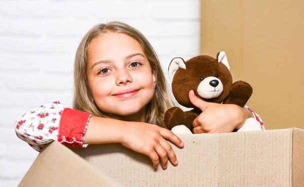 Express Your Individuality. purchase of new habitation. happy little girl with toy. happy child cardboard box. Cardboard boxes - moving to new house. repair of room. new apartment - Fotografie, Obrázek