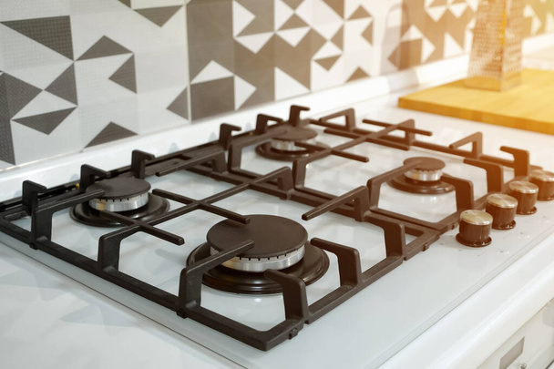 modern stainless steel silver gas stove with black elements - 写真・画像