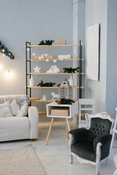 The interior of the living room or study, decorated for Christmas or new year, shelving or shelf and chair - Foto, immagini