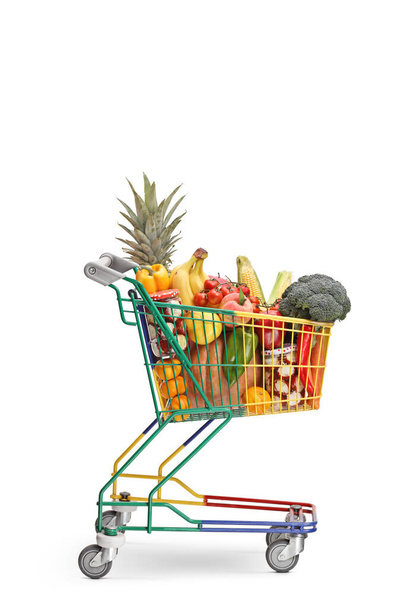 Studio shot of a little shopping cart full of healthy food produ - Foto, Imagem