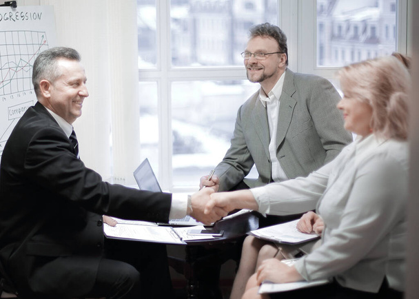 handshake of a businessman and business woman at a meeting - Φωτογραφία, εικόνα