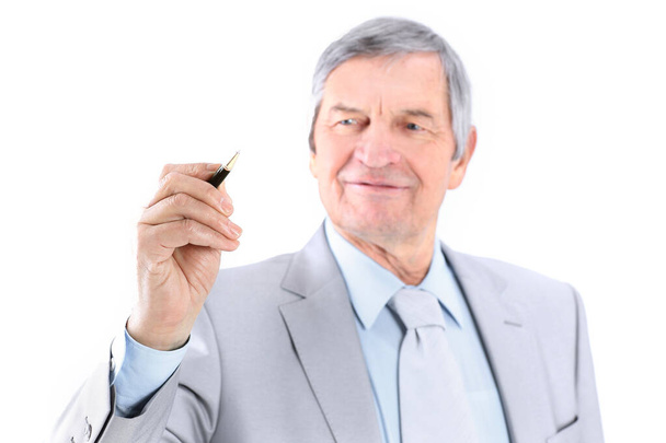 Mature businessman showing a pencil on the copy space. - Photo, image