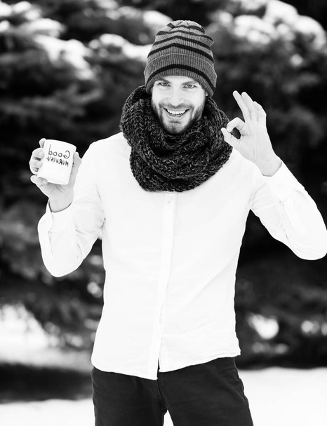 handsome man with morning cup in winter outdoor - Foto, imagen