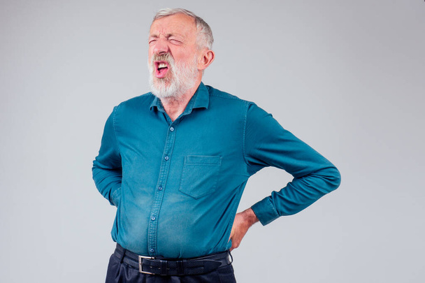 sick senior old man suffering face expression,spine ache pain in studio white background - Foto, afbeelding