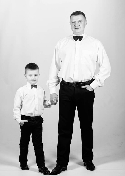Gentleman upbringing. Little son following fathers example of noble man. Gentleman upbringing. Visit theatre dress code. Father and son formal clothes outfit. Formal event. Grow up gentleman - Foto, Imagen