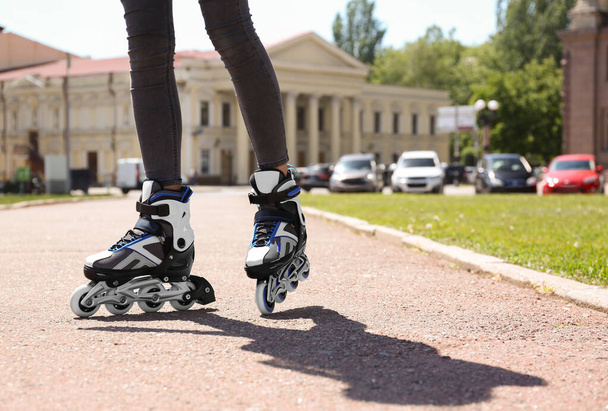 Woman with modern inline roller skates in city park, closeup - Foto, immagini