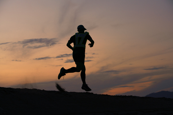 Trilha que corre na praia de areia por do sol de estilo de vida homens esporte
  - Foto, Imagem