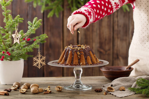 woman cooking christmas cake on wooden kitchen - Zdjęcie, obraz
