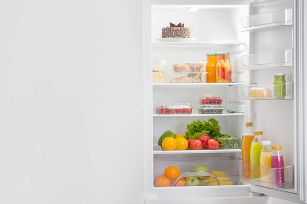  white fridge with different food - Foto, Imagem