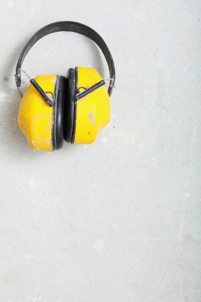 Yellow working protective headphones noise muffs - 写真・画像