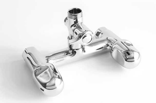 Bathroom water mixer. Water tap made of chrome material on white background - Photo, image
