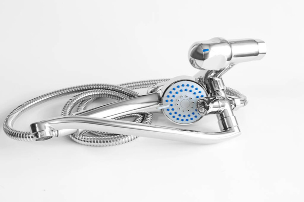 Water mixer and shower head for bathroom. Water tap made of chrome material on white background - Foto, immagini