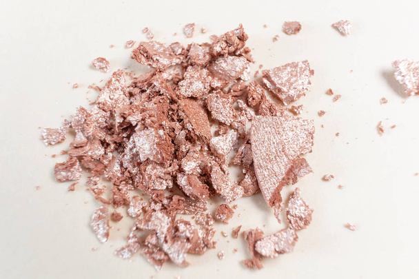 Scattered eyeshadows of beige shades on a light background. The concept of decorative cosmetics, makeup. Minimalism. Copy space. - Фото, зображення
