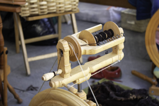 Spinning wool on spinning wheel - Photo, Image