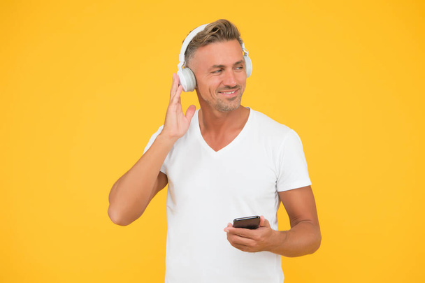 Wireless equal freedom. Guy modern user mobile application. Favorite music playlist. Music subscription. Man listen music modern headphones and smartphone. Listening concept. Best music apps - Valokuva, kuva
