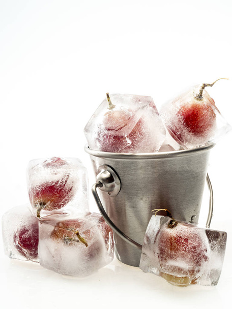 Grape inside ice on white background - Photo, Image