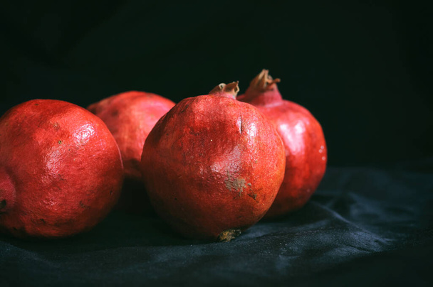 ripe pomegranates on a dark background - Fotó, kép