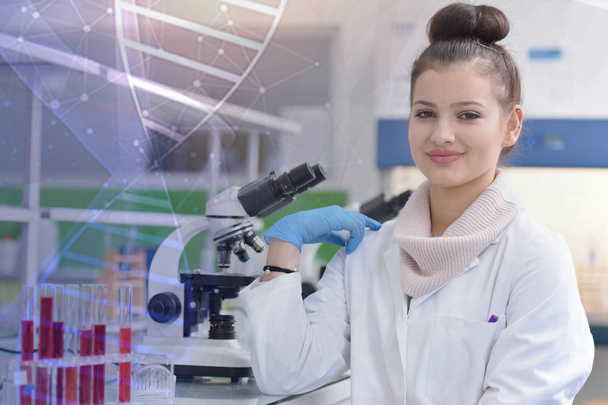 Young female scientist looking at camera and smilling during exp - Photo, Image