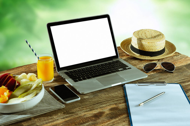 Blank laptop on a wooden table outdoors, mock up - Foto, Imagem