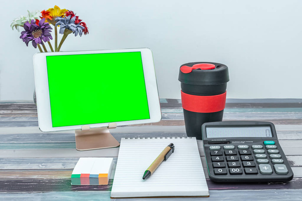 Stationery supplies, reusable cup and mobile tablet with green screen - Φωτογραφία, εικόνα