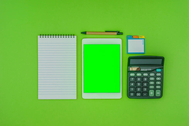 Office and school stationery, green screen tablet, on green background - Photo, Image