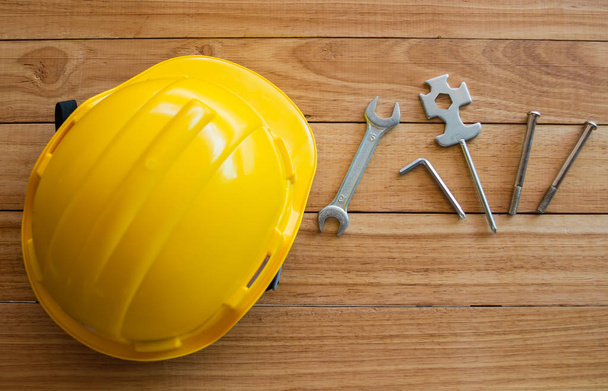 safety helmet and tools on wooden board from top view  - Photo, Image