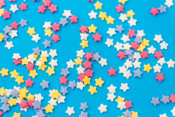 star shaped pastry sprinkles on blue background - Valokuva, kuva