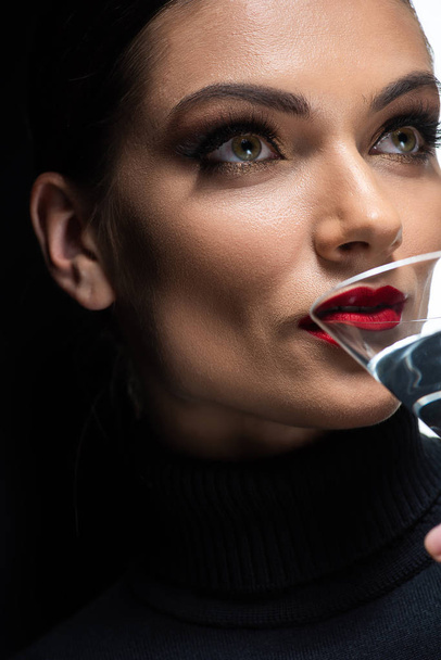 close up view of beautiful elegant woman with red lips drinking martini - 写真・画像