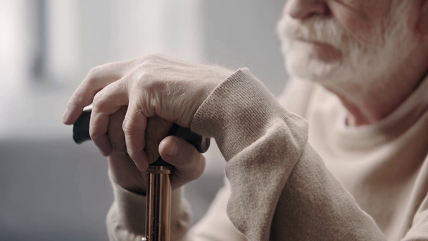 Senior man with dementia holding walking stick - Záběry, video