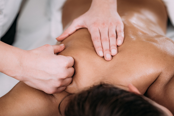 Fisioterapista massaggiare paziente femminile con scapola ferita. Trattamento infortuni sportivi
. - Foto, immagini