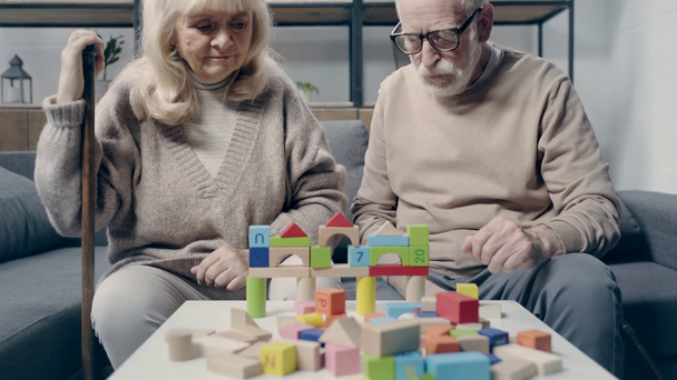Senior couple with dementia playing with building blocks - Footage, Video