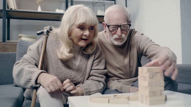 Oudere paar met dementie spelen in blokken hout spel - Video