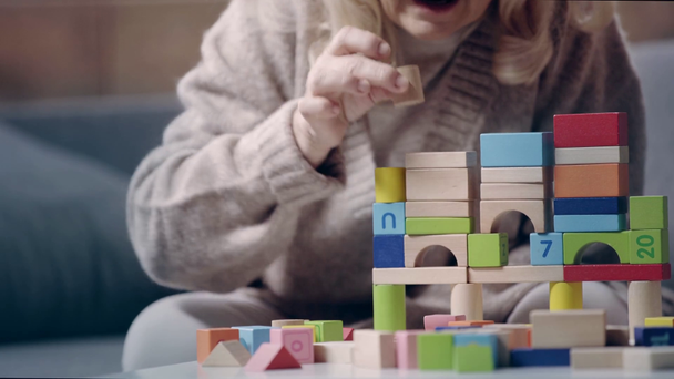Senior woman with dementia playing with building blocks - Footage, Video