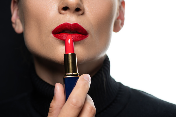 cropped view of beautiful woman with red lips applying lipstick isolated on white and black - Фото, зображення