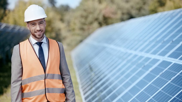 businessman looking at solar panel and smiling at camera  - Footage, Video