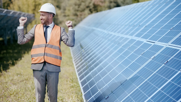 smiling businessman dancing near solar panels  - Footage, Video