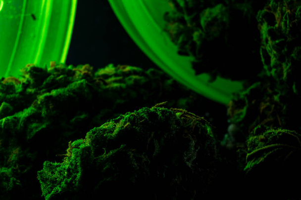 2x Macro close up of marijuana bud inside a bright green RX bott - Photo, Image