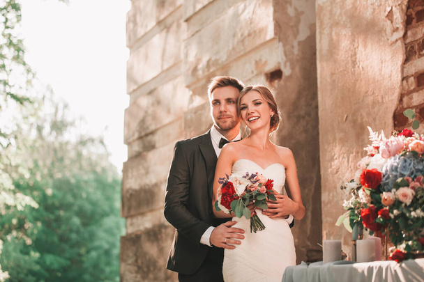portrait of happy bride and groom standing together - Fotografie, Obrázek