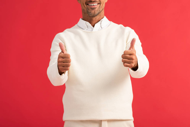 cropped view of cheerful man showing thumbs up isolated on red  - Photo, Image