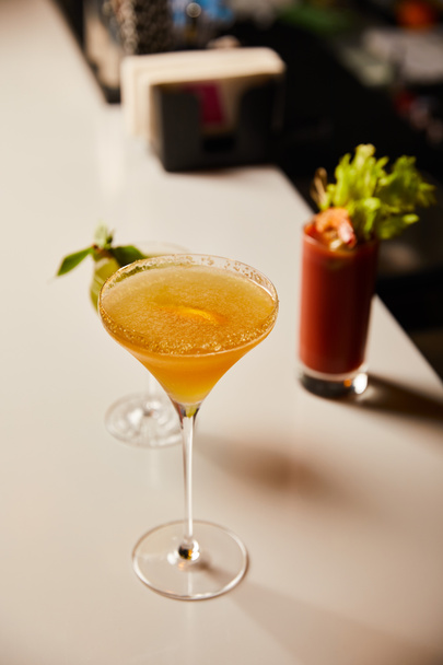 selective focus of cold cocktails in glasses on bar stand - Foto, Imagem