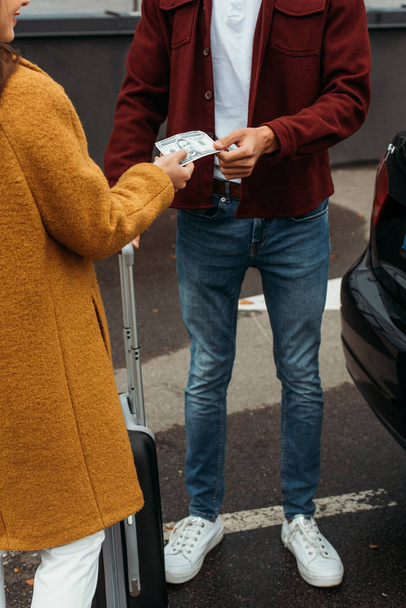 Cropped view of woman paying off with taxi driver - Fotografie, Obrázek