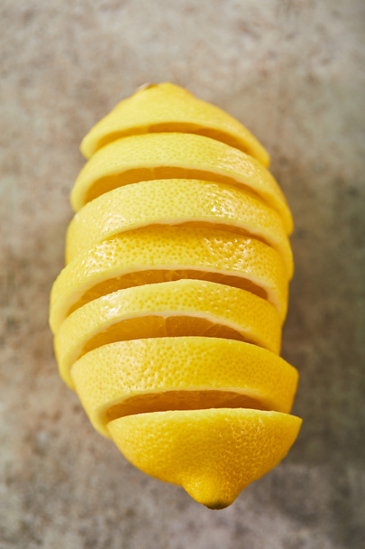 top view of sliced and ripe lemon on marble surface  - Photo, Image