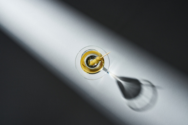 Top view of glass of martini with shadow on grey background - Fotografie, Obrázek