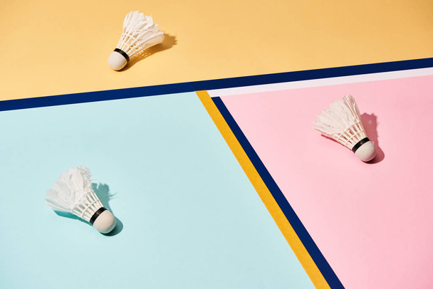 Badminton shuttlecocks on colorful background with blue lines - Фото, изображение